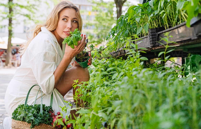 Woman smelling mint plant